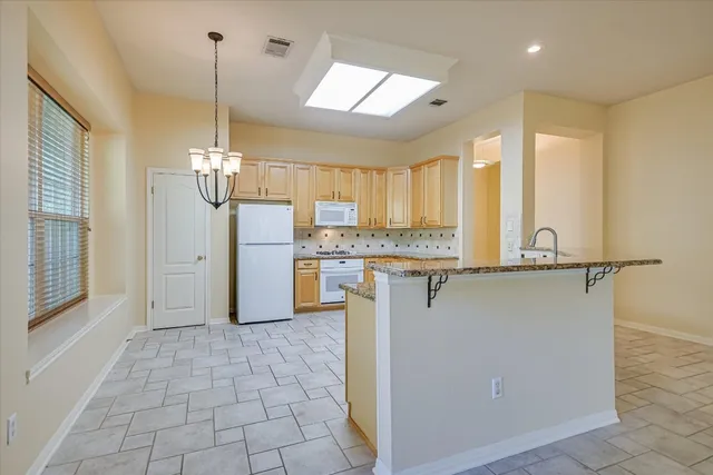 a view of a kitchen with a sink and a fireplace