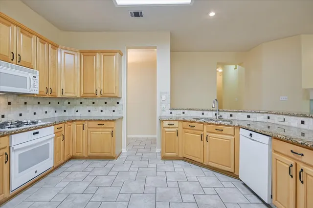 a kitchen with refrigerator and cabinets