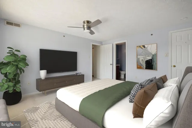 a bedroom with a large bed and a television