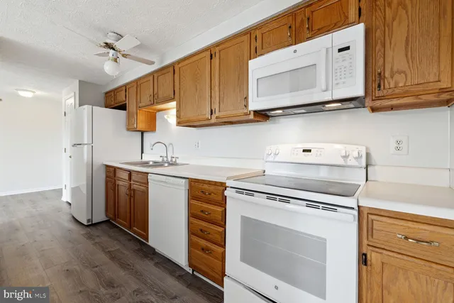 a kitchen with stainless steel appliances granite countertop a sink a stove and cabinets