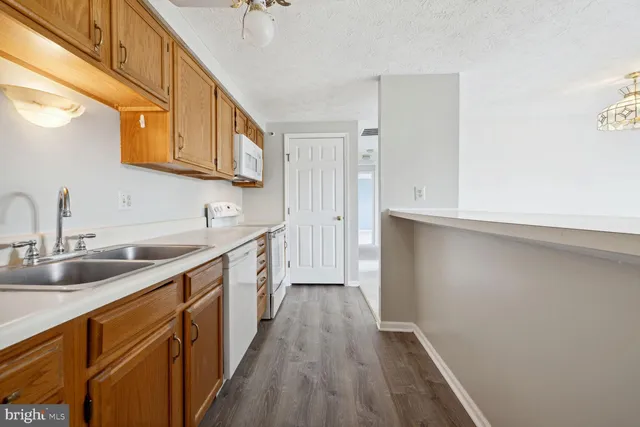 a kitchen with stainless steel appliances a sink and cabinets