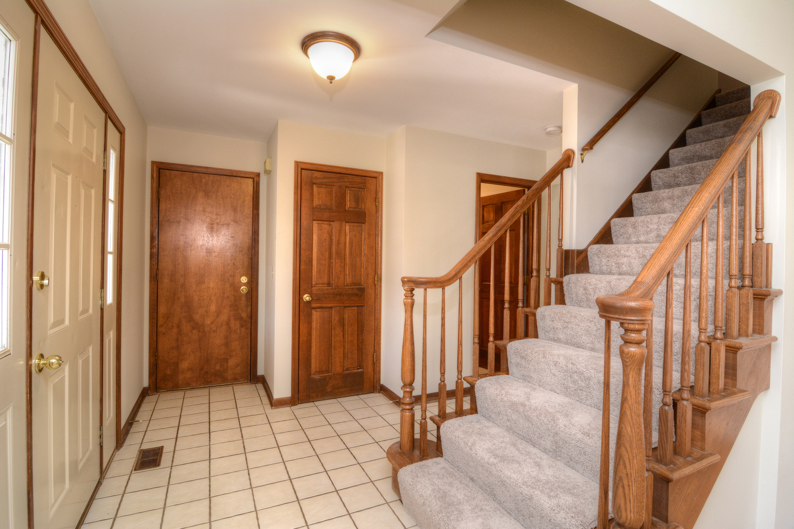 1950 Huntington Road St. Charles, IL 60174 - Photo 2 of 26 a view of an entryway with wooden floor and staircase