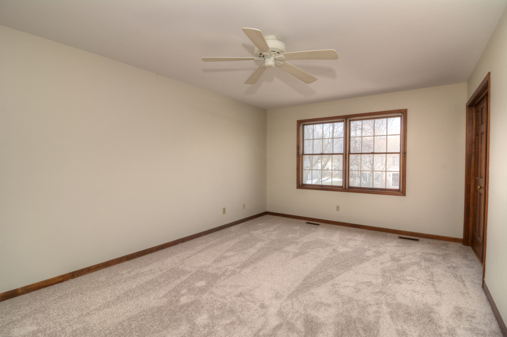 1950 Huntington Road St. Charles, IL 60174 - Photo 18 of 26 an empty room with windows and ceiling fan view