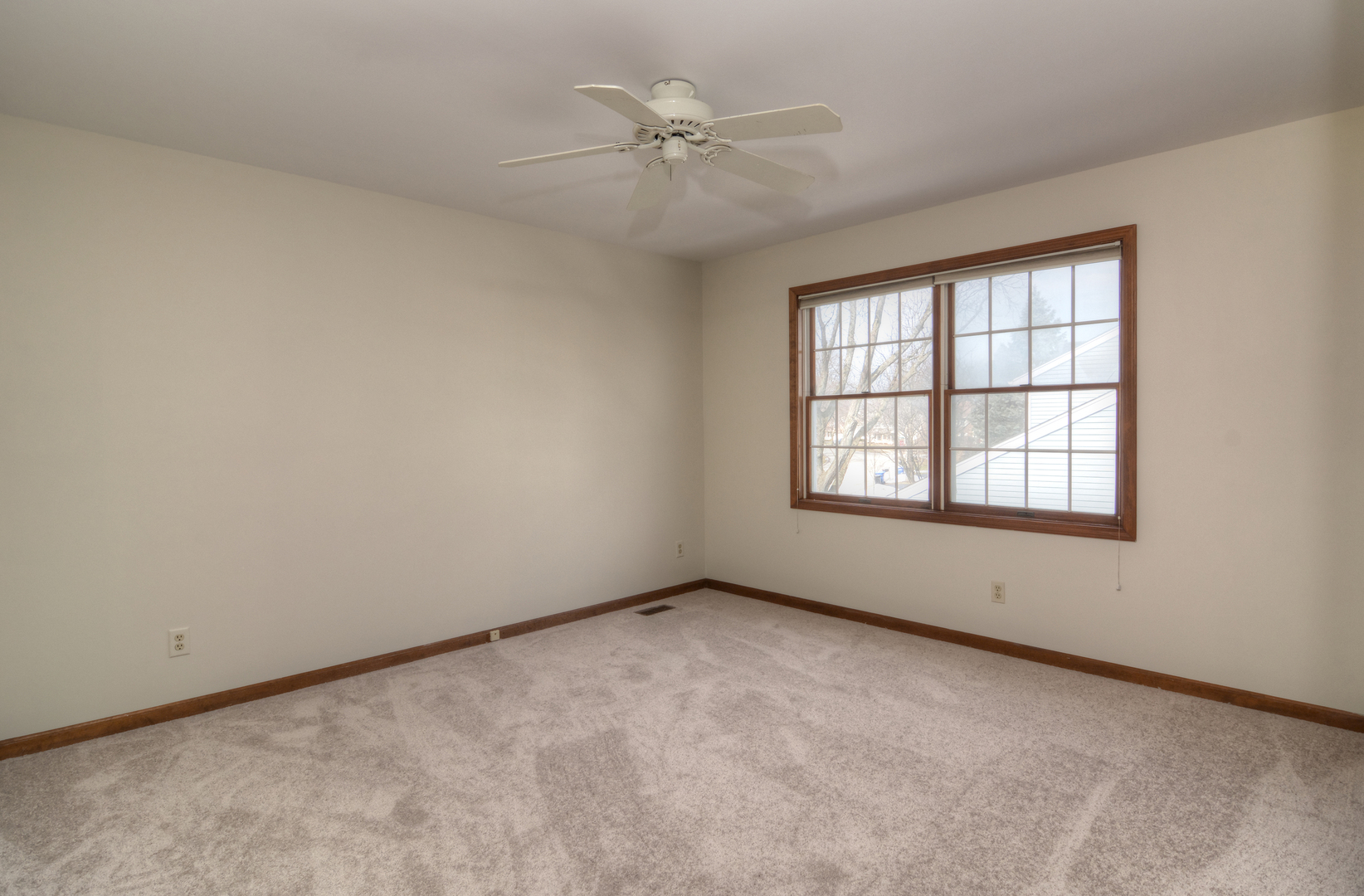 1950 Huntington Road St. Charles, IL 60174 - Photo 22 of 26 an empty room with a window and a ceiling fan