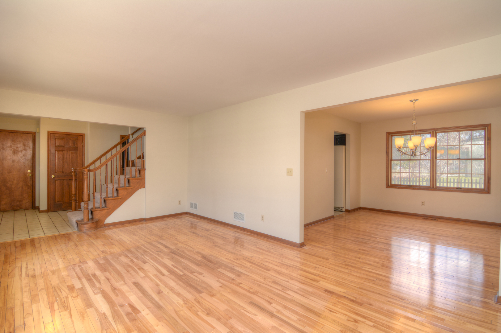 1950 Huntington Road St. Charles, IL 60174 - Photo 6 of 26 a view of an empty room with window and wooden floor