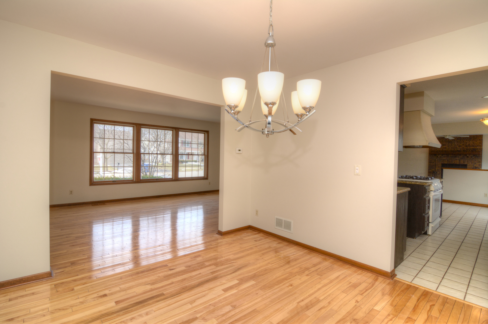 1950 Huntington Road St. Charles, IL 60174 - Photo 7 of 26 a view of an empty room with wooden floor and a window