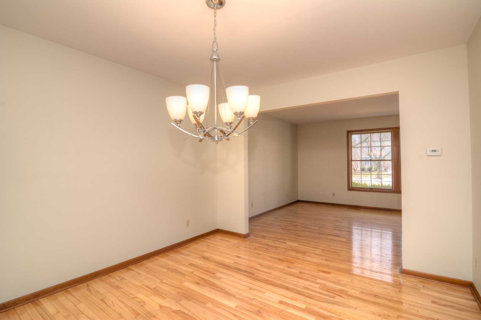 1950 Huntington Road St. Charles, IL 60174 - Photo 8 of 26 a view of a room with a chandelier fan and wooden floor