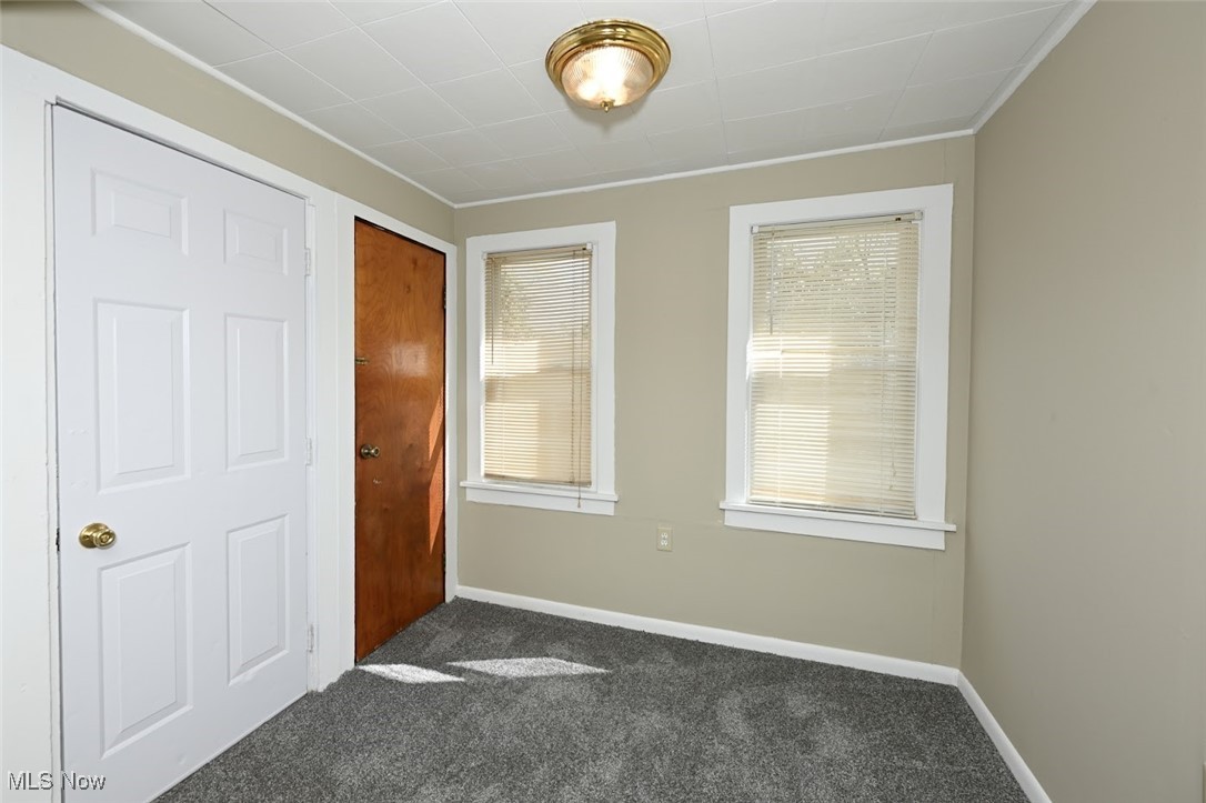364 Stanley Road Akron, OH 44312 - Photo 17 of 29 Unfurnished bedroom featuring dark colored carpet, multiple windows, and a closet
