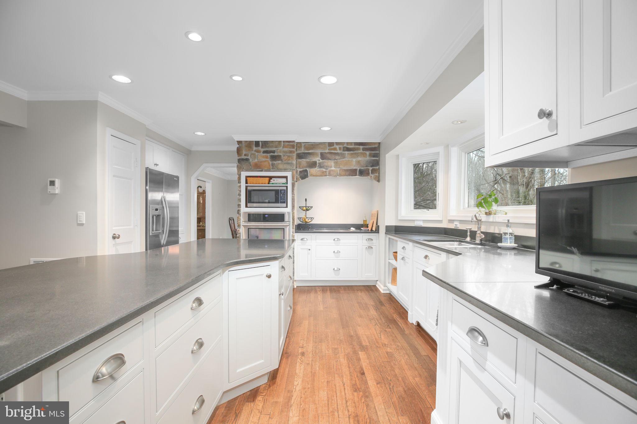 9 Old Ridge Road Fredericksburg, VA 22407 - Photo 17 of 110 a large kitchen with stainless steel appliances and white cabinets