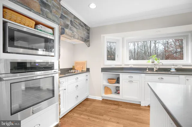 a spacious bedroom with a bed and chair