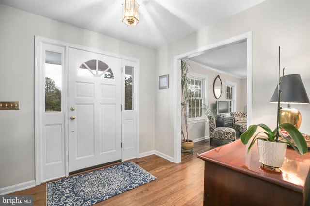 a living room with furniture a table and a large window