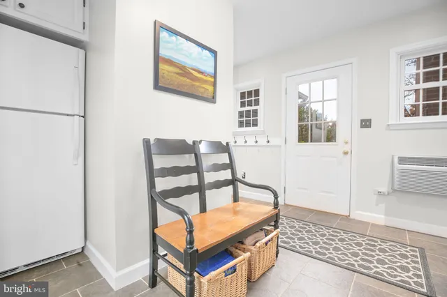 a living room with furniture a rug and a window