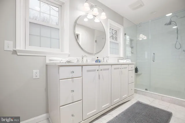 a bathroom with a sink vanity mirror and toilet