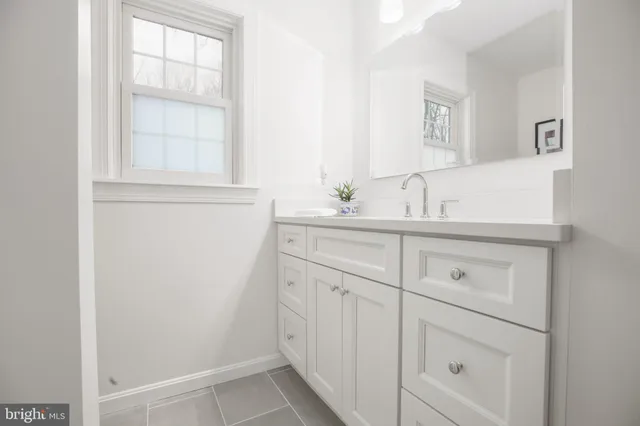 front view of a brick house with a yard