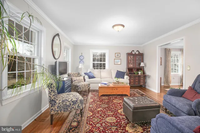a dining room with furniture a chandelier and wooden floor