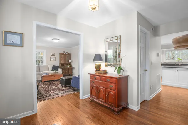 a dining room with furniture a chandelier and wooden floor