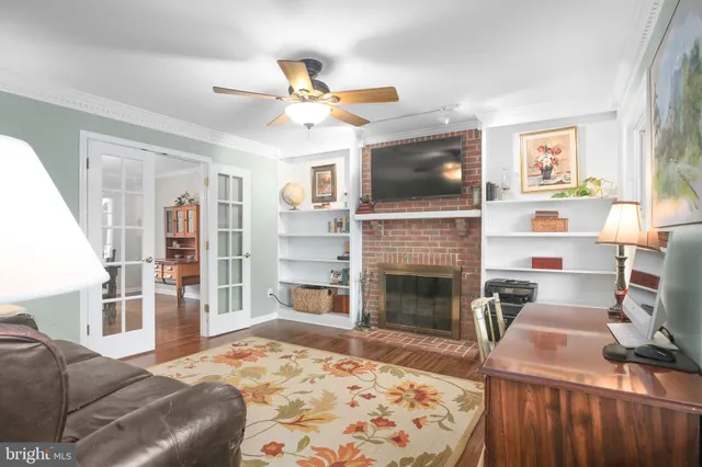 a dining room with furniture a chandelier and wooden floor