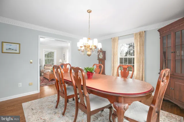 a large kitchen with stainless steel appliances and white cabinets