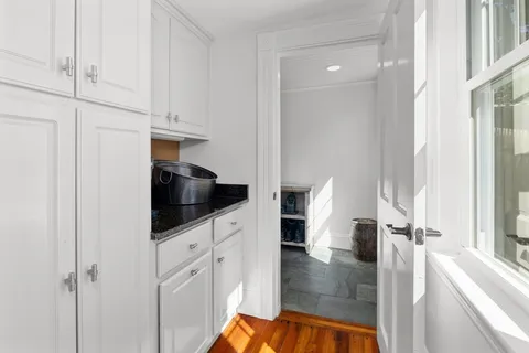 a kitchen with white cabinets and white appliances