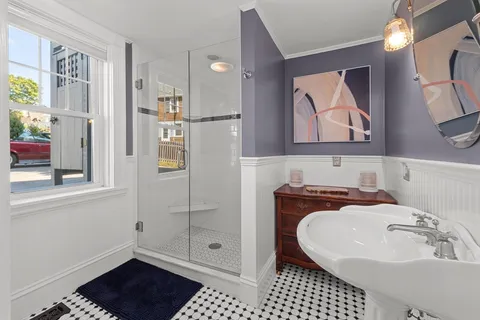 a bathroom with a sink a mirror and shower