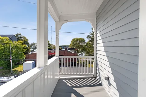 a view of an entryway with wooden floor