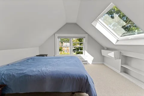 a white bath tub sitting in a bathroom with mirror