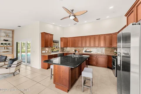 a kitchen with granite countertop a sink stove and refrigerator