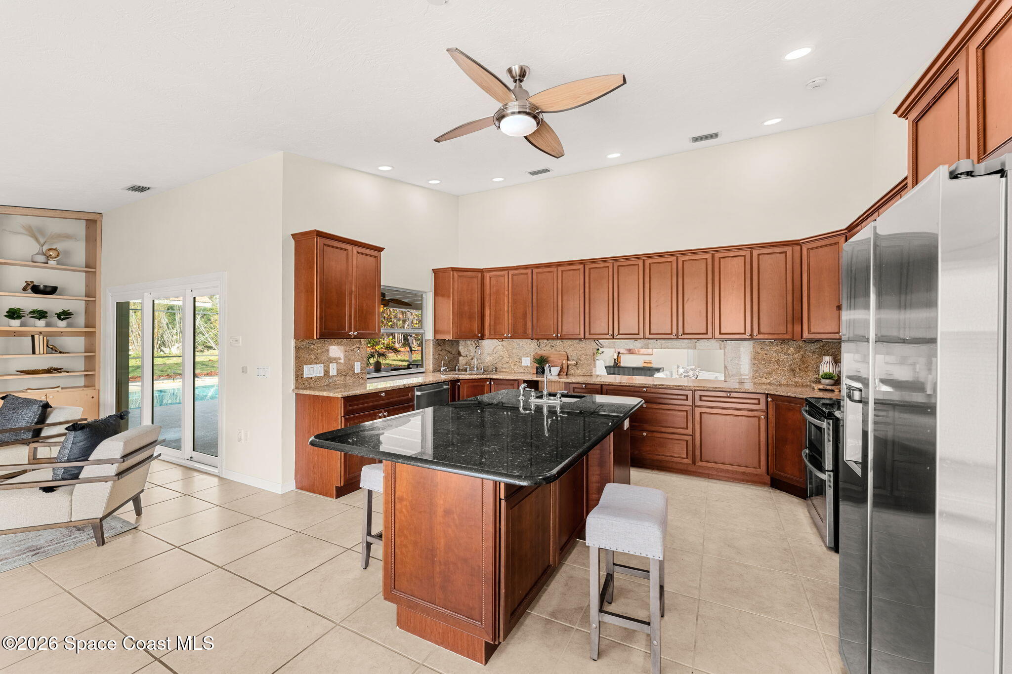 3070 Rio Plumosa North Indialantic, FL 32903 - Photo 11 of 29 a kitchen with granite countertop a sink stove and refrigerator