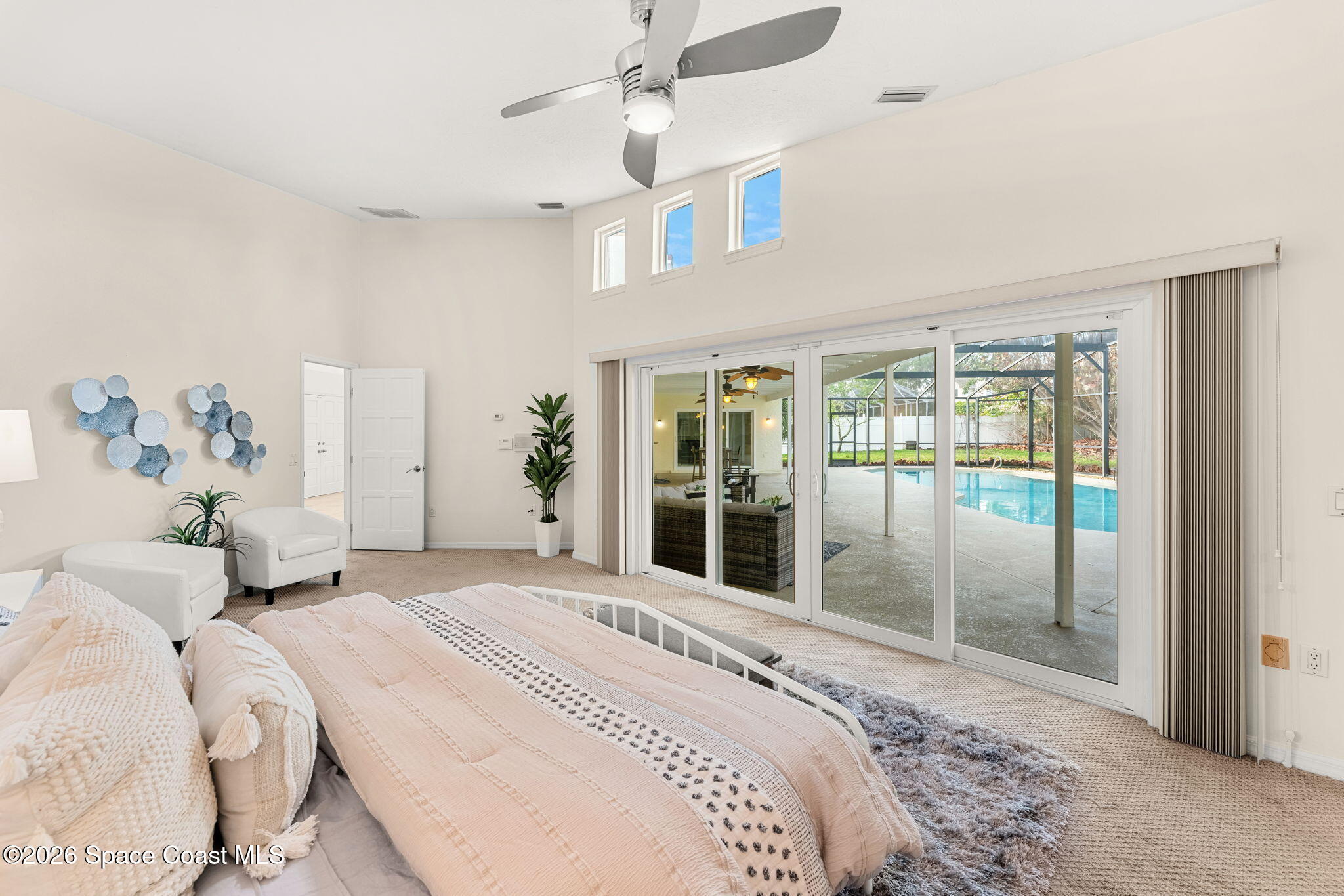 3070 Rio Plumosa North Indialantic, FL 32903 - Photo 12 of 29 a bedroom with a large bed and a chandelier