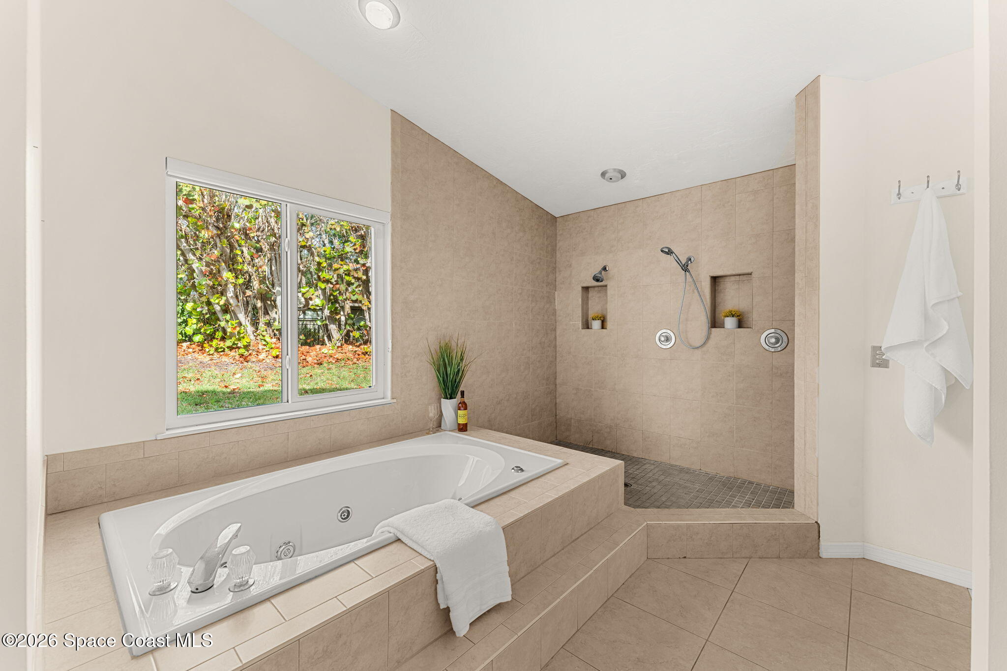3070 Rio Plumosa North Indialantic, FL 32903 - Photo 14 of 29 a bathroom with a tub a window and a shower