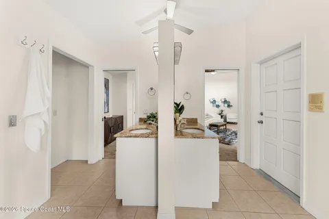 a living room with furniture a refrigerator and a table