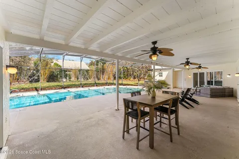 a view of a patio with a table and chairs