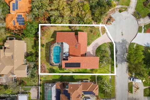 an aerial view of a house with outdoor space and sitting area
