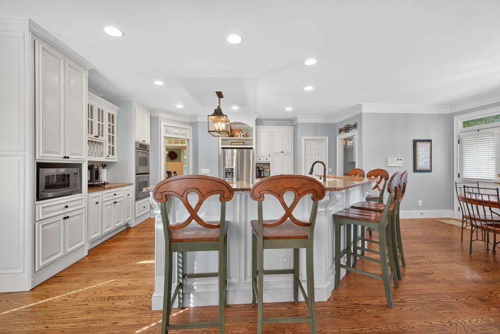 3315 Kylee Dawn Circle Lawrenceville, GA 30045 - Photo 17 of 97 a view of a dining room with furniture and wooden floor
