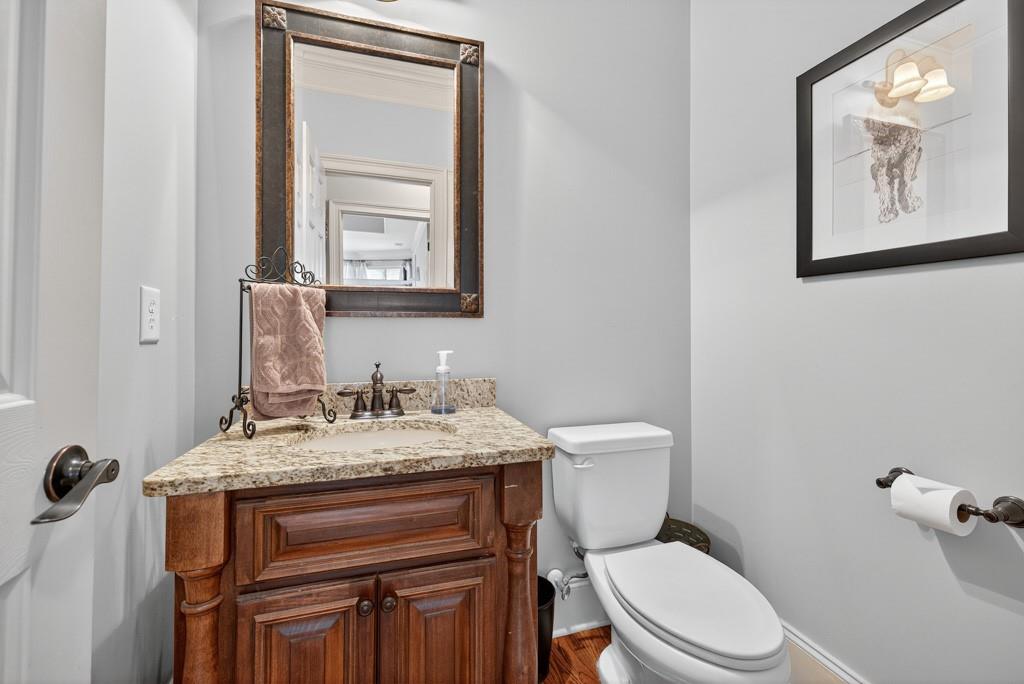 3315 Kylee Dawn Circle Lawrenceville, GA 30045 - Photo 29 of 97 a bathroom with a granite countertop toilet sink and mirror