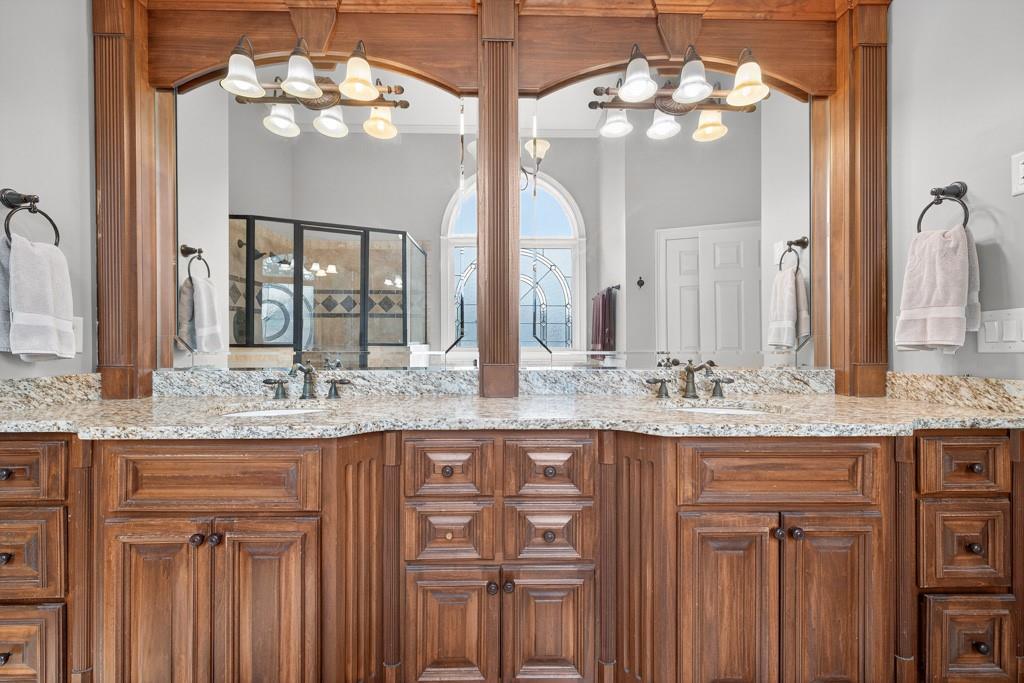 3315 Kylee Dawn Circle Lawrenceville, GA 30045 - Photo 31 of 97 a bathroom with a granite countertop sink two large mirror and cabinets