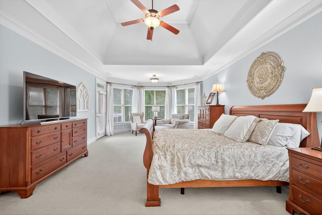 3315 Kylee Dawn Circle Lawrenceville, GA 30045 - Photo 36 of 97 a bedroom with a large bed and a chandelier