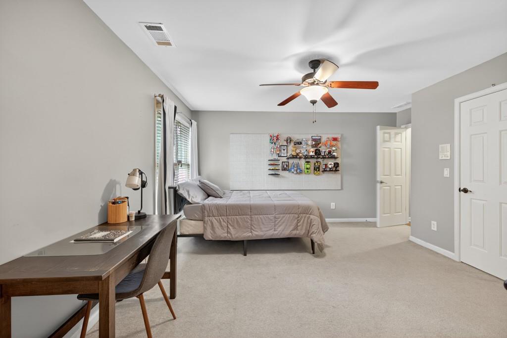 3315 Kylee Dawn Circle Lawrenceville, GA 30045 - Photo 42 of 97 a bedroom with a bed and a chandelier