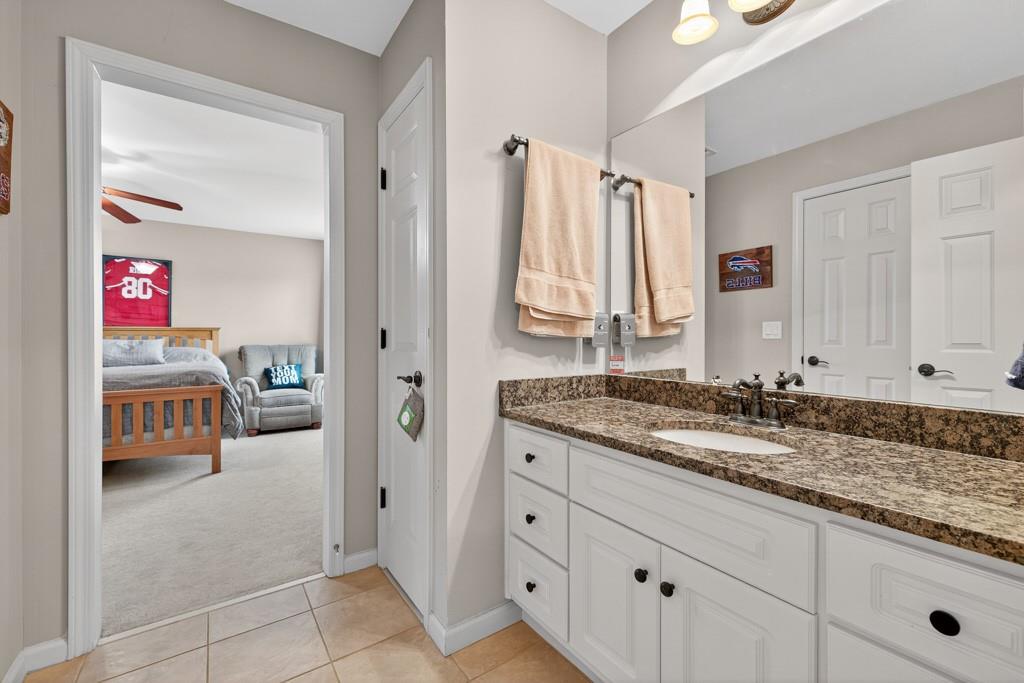 3315 Kylee Dawn Circle Lawrenceville, GA 30045 - Photo 47 of 97 a en suite bathroom with a granite countertop sink and a mirror