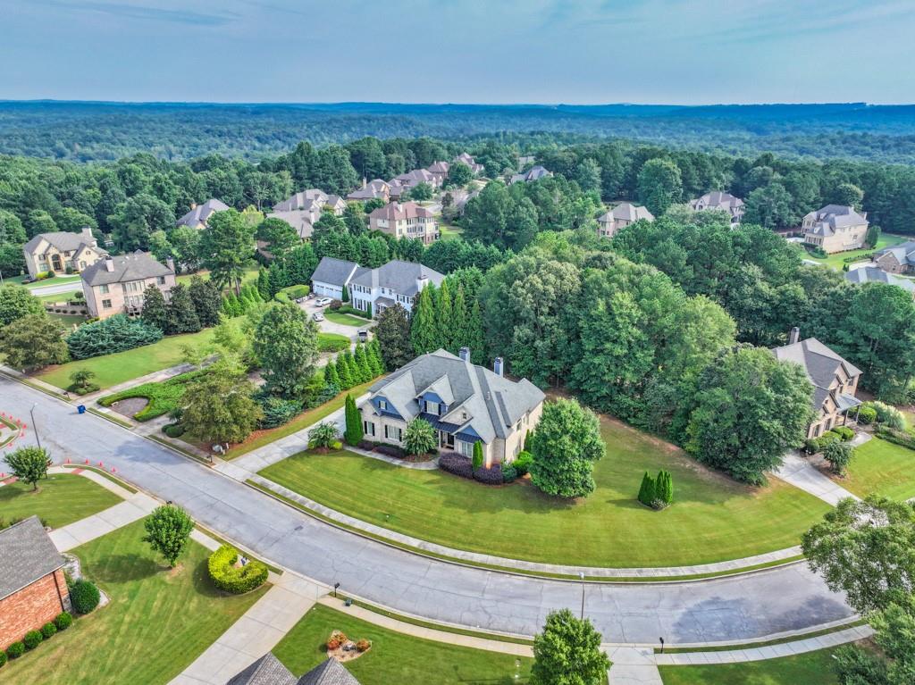 3315 Kylee Dawn Circle Lawrenceville, GA 30045 - Photo 87 of 97 an aerial view of a house with a yard and lake