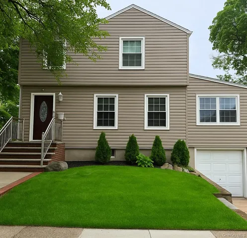 a view of a house with a backyard