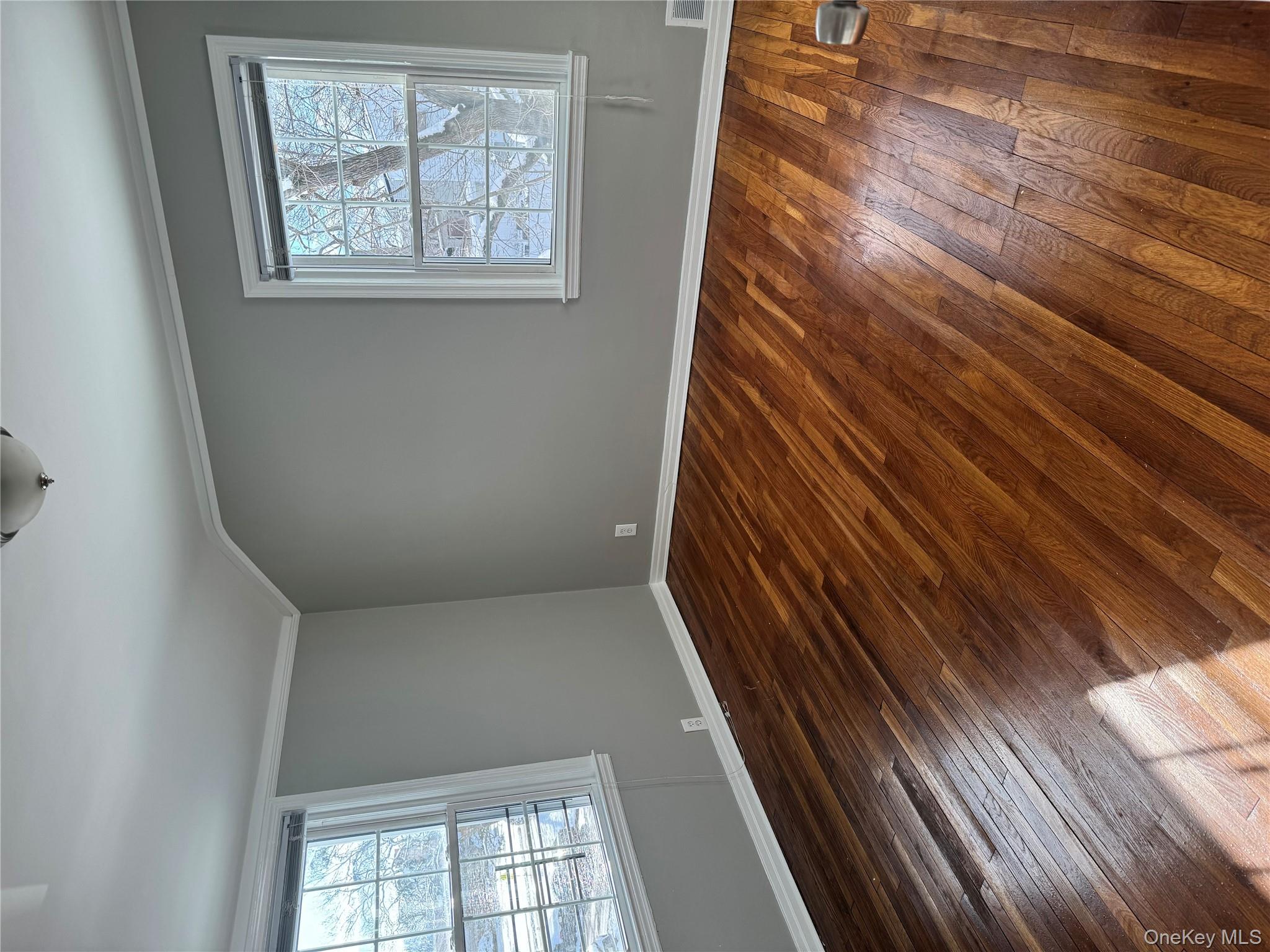 31 Flower Road Valley Stream, NY 11581 - Photo 11 of 16 Unfurnished room featuring wood-type flooring and ornamental molding