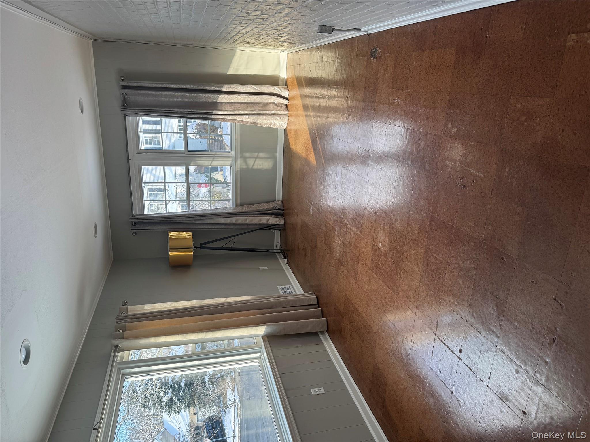 31 Flower Road Valley Stream, NY 11581 - Photo 5 of 16 Spare room with baseboards and tile patterned floors