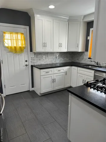 a kitchen with a sink and cabinets