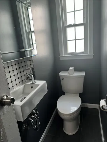 a white toilet sitting next to a window