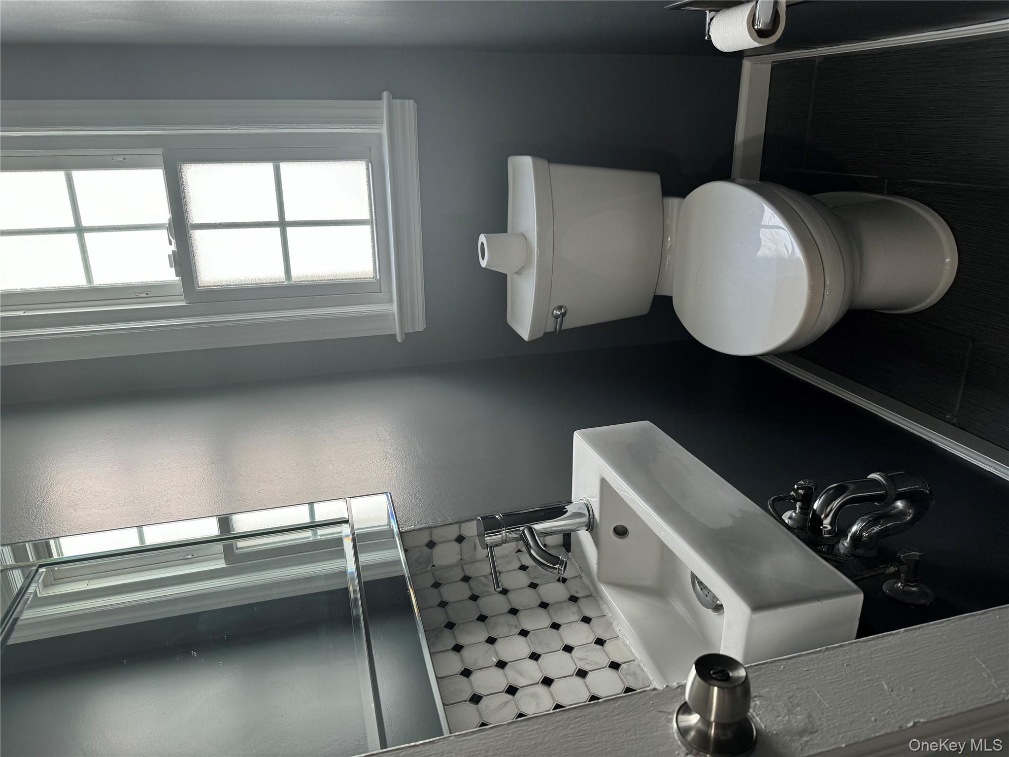 31 Flower Road Valley Stream, NY 11581 - Photo 8 of 16 Bathroom with backsplash and toilet