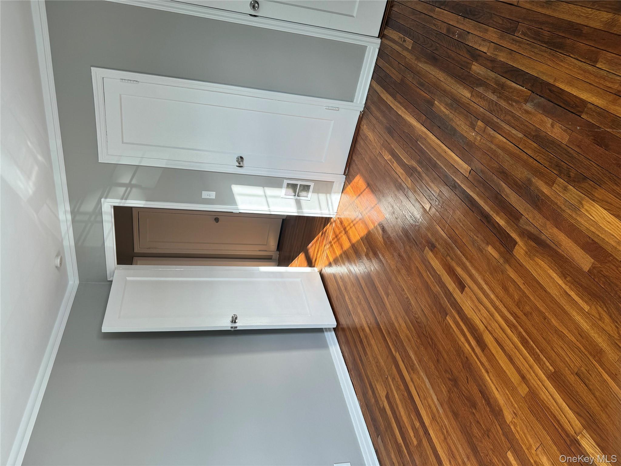 31 Flower Road Valley Stream, NY 11581 - Photo 10 of 16 Unfurnished bedroom featuring crown molding and dark wood-type flooring