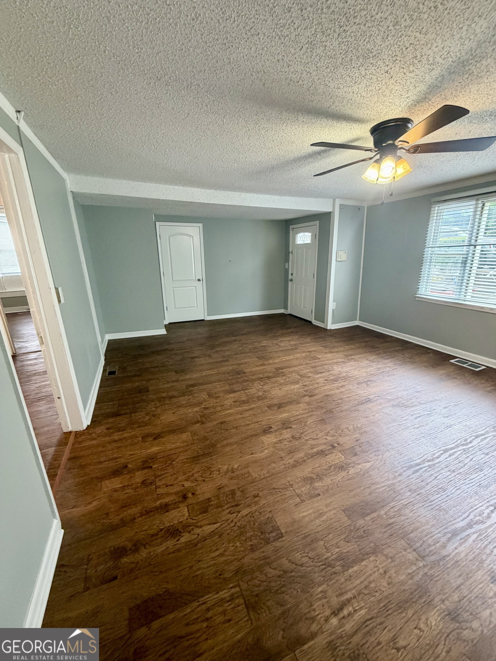 666 Woolfolk Street Macon, GA 31217 - Photo 9 of 60 a view of an empty room with window and stairs