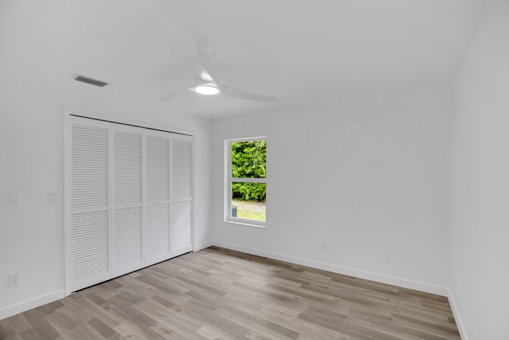 4384 2nd Square Southwest Vero Beach, FL 32968 - Photo 20 of 36 wooden floor in an empty room with a window