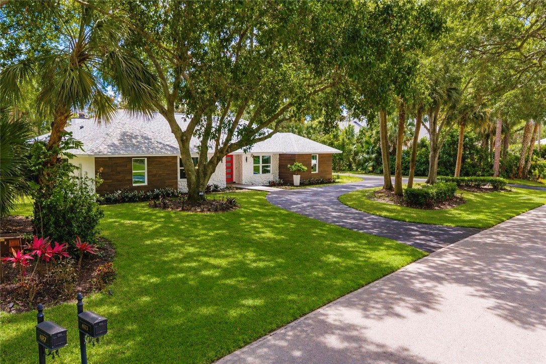 4384 2nd Square Southwest Vero Beach, FL 32968 - Photo 2 of 36 a front view of a house with garden